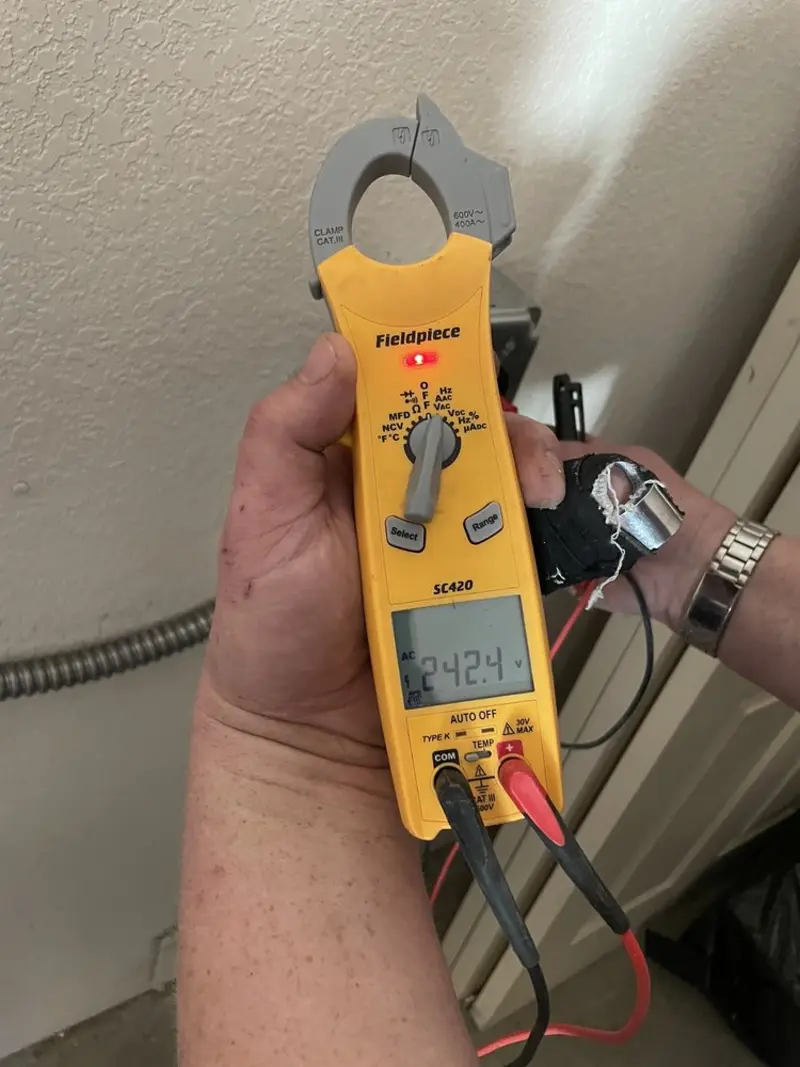 Voltage testing with clamp meter during Outlet Installation in Lake Arbor